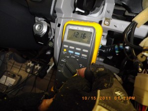 Using a multimeter to test stock stereo harness wires.